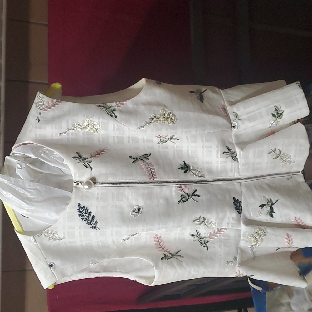 Ladies  embroidered sleeveless zip front blouse with pearl like zipper pull..f